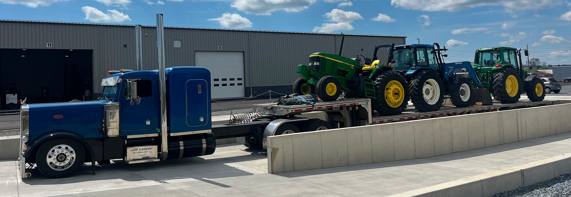 Blue truck towing tractors
