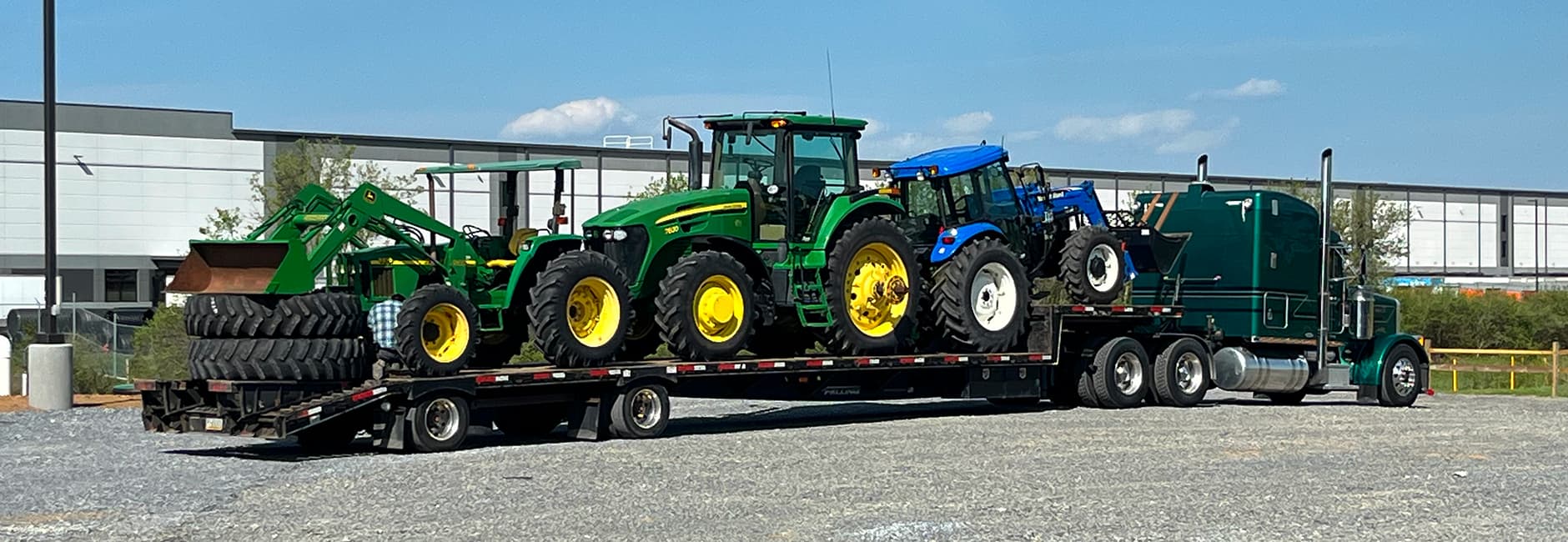 green truck towing a green tractor
