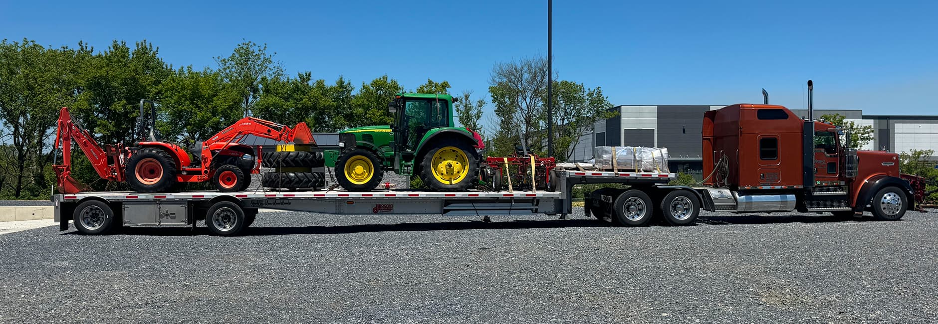 tractor on a red trucks flatbed